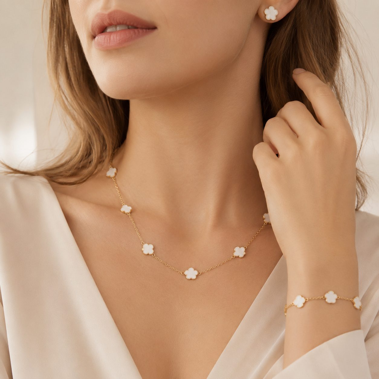 Outfit Model wearing a delicate clover necklace, bracelet and earrings with gold chain for a feminine light luxury style