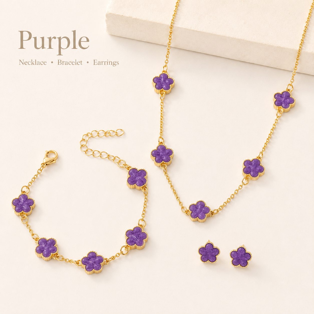 Purple clover jewelry set with necklace, bracelet, and earrings, displayed on a clean background for ecommerce