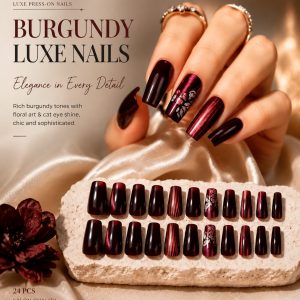 Burgundy press-on nails with glossy cat-eye shimmer, floral accent design, and elegant salon-style finish for a luxury manicure look.