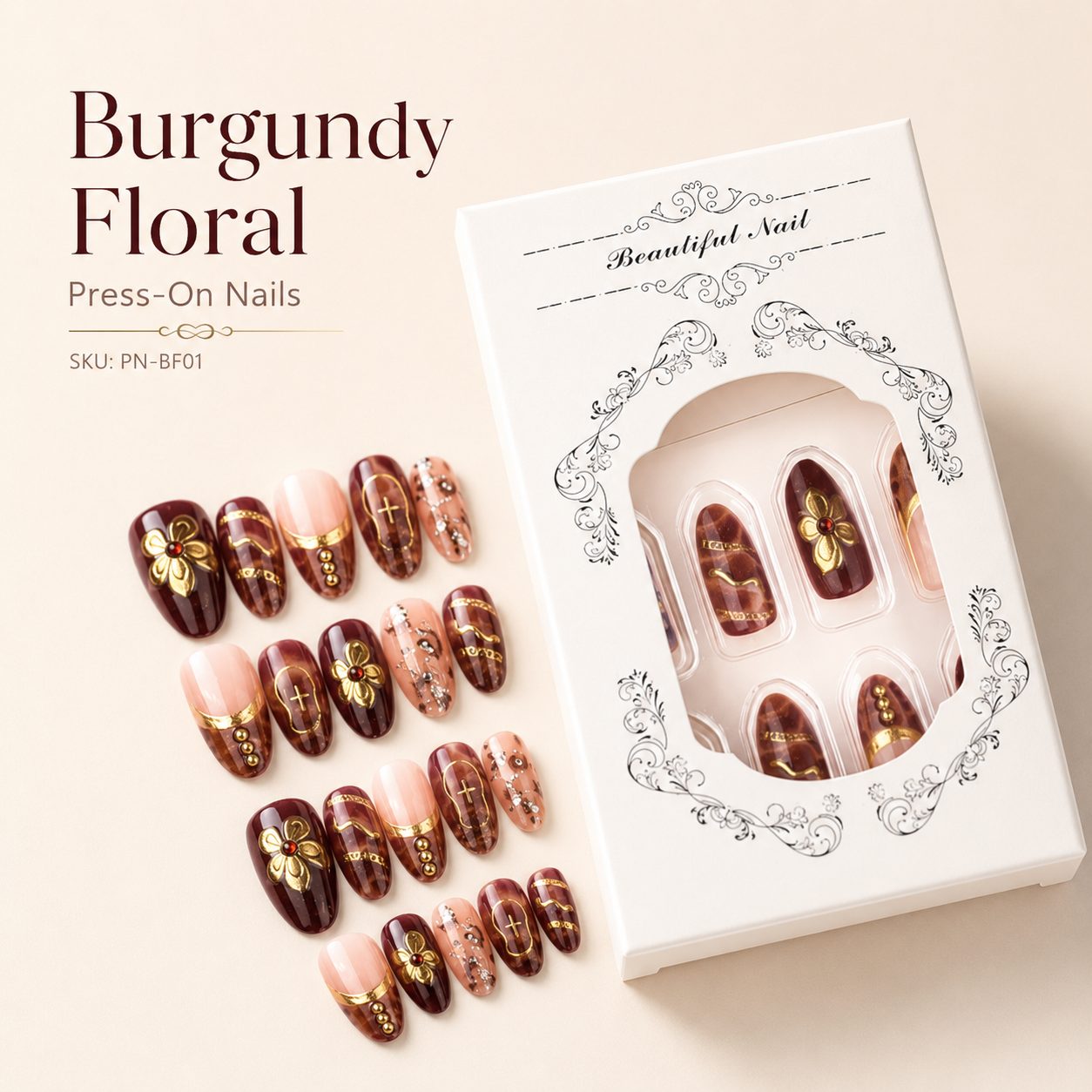 Elegant burgundy floral press-on nails set with nude pink design, gold floral accents, rhinestone details, and luxury white packaging