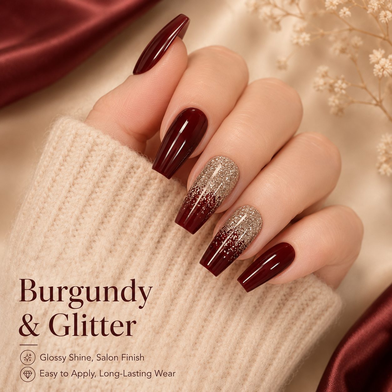 Hand wearing glossy burgundy and champagne glitter press-on nails with long coffin shape and elegant salon look