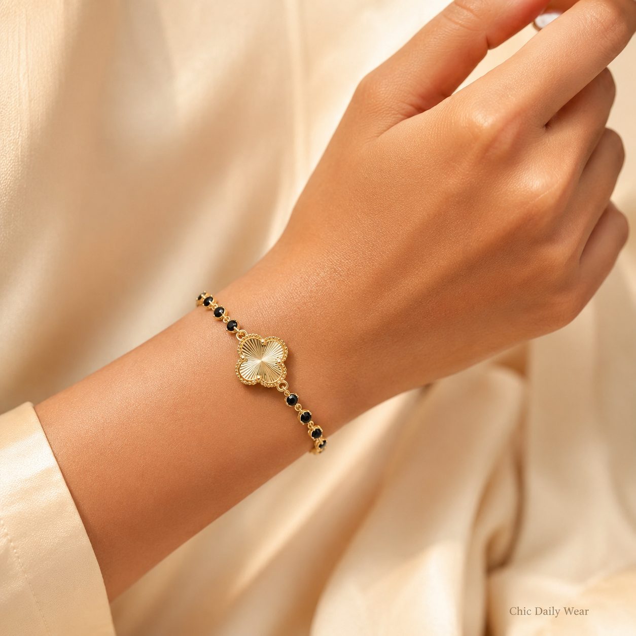 Silver lucky clover bracelet worn on wrist with clear sparkling stones in a luxury hand close up