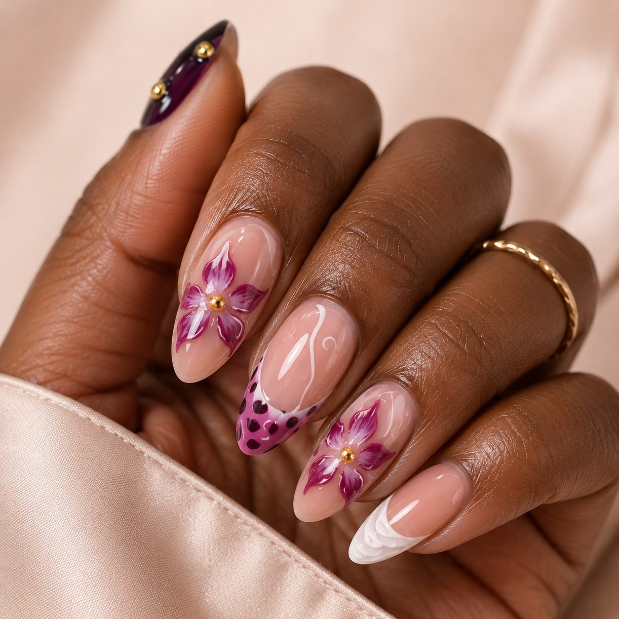 pink floral press on nails on dark skin hand